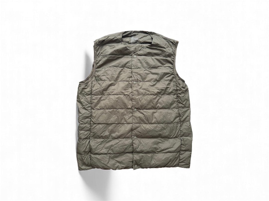 Muji Light weight down Vest (Category: Vests) located in Trece Martires City. Submitted by lakingking (Listing ID 1410401198, Image 1). Description: - Olive green vest - Size: XL - Outer shell: Nylon - Lining: Nylon/Spandex - Closure: Button - Lightweight and versatile for layering - Suitable for various weather conditions.