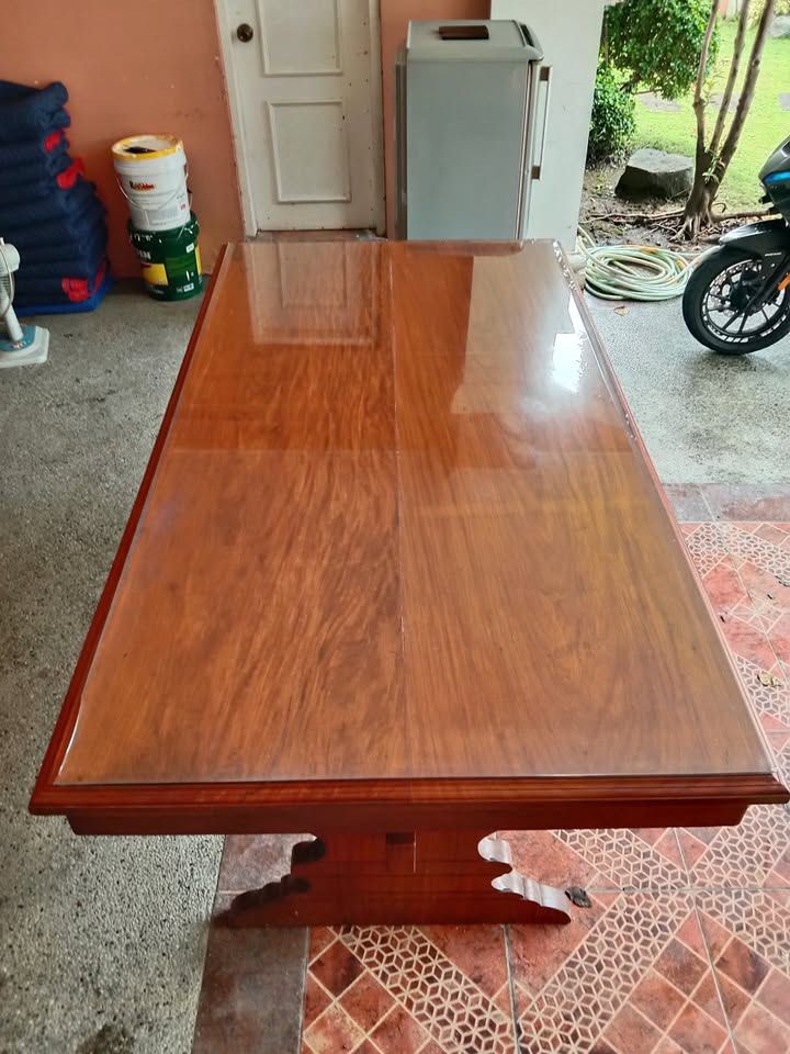 Narra Dining Table with Glass Top (Category: Tables & Sets) located in Paranaque City. Submitted by nihaonica (Listing ID 1410375591, Image 3). Description: - Elegant wooden dining table - Glass top - Warm wood finish - Two storage drawers - Unique leg design - Sturdy and well-maintained - Perfect for dining rooms or as a statement piece Specifications: • Material: 100% Solid Narra hardwood • Length: Approximately 6-7 feet • Width: Approximately 