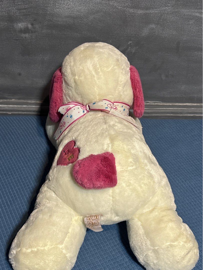 Pink & White Dog Plush Toy (Category: Plushies & Soft Toys) located in Quezon City. Submitted by _rronnie (Listing ID 1410532517, Image 2). Description: - Made by Gift Factory - Pink & White Dog Plush Toy - Features pink ears and heart details.