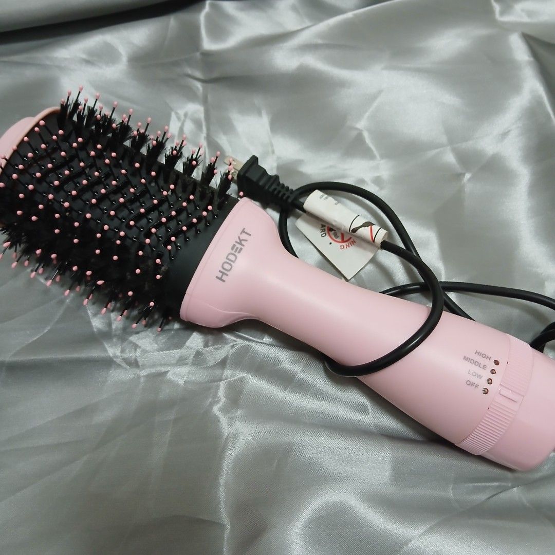 Pink Hair Dryer Brush (Category: Hair) located in Quezon City. Submitted by marceline_am (Listing ID 1410479414, Image 1). Description: - HODEKT hair dryer brush - Pink body - Round brush head - Heat settings: High, Middle, Low, Off - Black bristles with pink tips - Includes power cord.