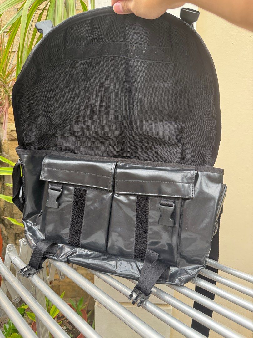 Porter Black Patent Messenger Bag (Category: Sling Bags) located in Paranaque City. Submitted by declutteringstuff (Listing ID 1410499810, Image 3). Description: Great for quick errands outside! has 5 spacious pockets inside for smaller scaled items, perfect for phones, powerbanks, perfume bottles, etc. padded shoulder strap for comfortability even with heavier loads minor issue, small hole under the bag (1 layer), nothing major perfectly usable 
