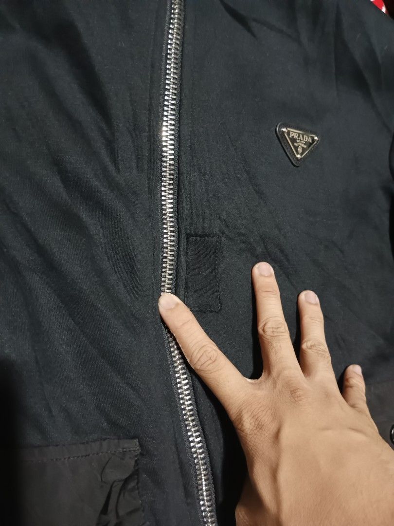 Prada (Category: Activewear) located in San Pablo. Submitted by thriftyjd (Listing ID 1410507616, Image 3). Description: Prada Bomber Windbreaker Jacket Dimes: L27 x W23 Condition/color rate: 9.5/10 Issue: repaired patch hole, all goods na nego.