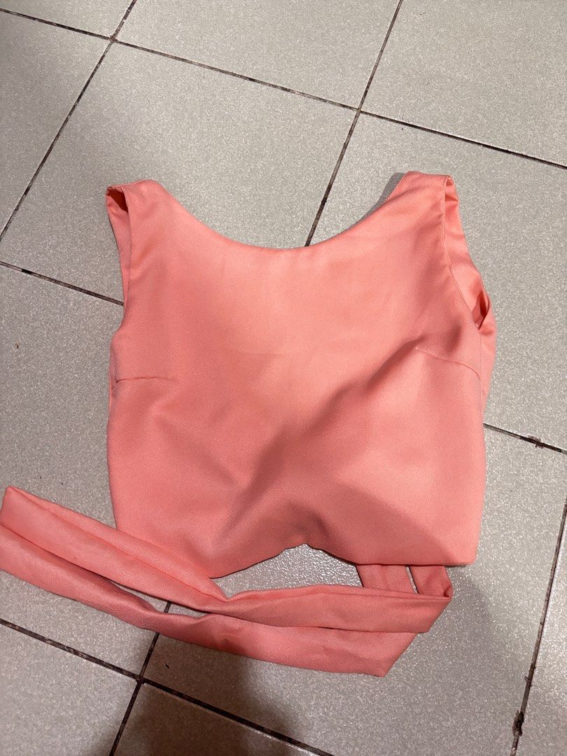 Salmon Pink Peach-colored Tie-Back Crop Top (Category: Others Tops) located in Taguig. Submitted by barbequeIU (Listing ID 1410411028, Image 1). Description: - Peach crop top - Tie-back design for adjustable fit - Sleeveless - Scoop neckline - Smooth, possibly satin-like fabric - Versatile style - Backless.