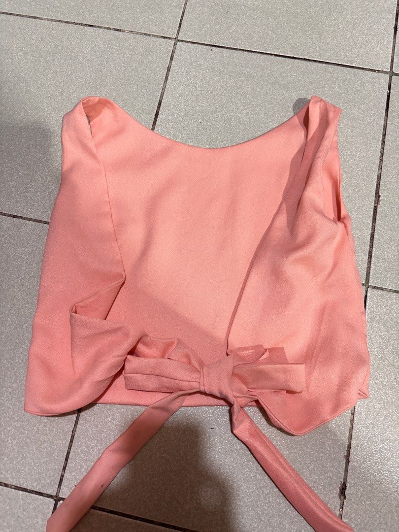 Salmon Pink Peach-colored Tie-Back Crop Top (Category: Others Tops) located in Taguig. Submitted by barbequeIU (Listing ID 1410411028, Image 2). Description: - Peach crop top - Tie-back design for adjustable fit - Sleeveless - Scoop neckline - Smooth, possibly satin-like fabric - Versatile style - Backless.