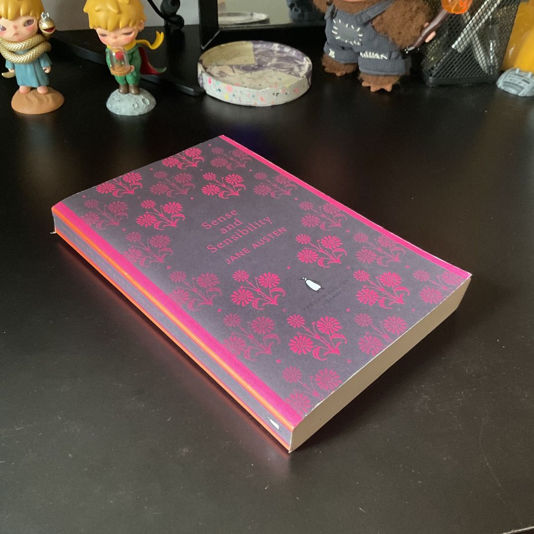 Sense and Sensibility by Jane Austen (Category: Storybooks) located in Mandaluyong City. Submitted by ynomaki (Listing ID 1410388337, Image 3). Description: Copy of Jane Austen's classic novel, "Sense and Sensibility." Published by Penguin English Library. The book features a decorative cover with a floral pattern in pink and gray. The back cover includes a brief summary of the story. The spine is visible, and the pages appear to be intact..