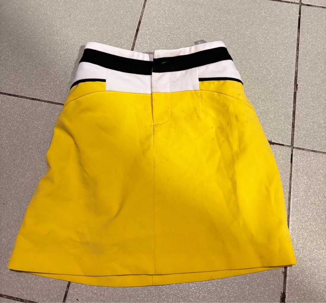 Yellow Mini Skirt with Color Block Detail (Category: Skirts) located in Taguig. Submitted by barbequeIU (Listing ID 1410411237, Image 1). Description: 25-26 - Vibrant yellow skirt - Unique color block waistband (white and black) - Classic A-line silhouette - Made of smooth, possibly woven fabric - Simple and clean design - Great for casual outfits.