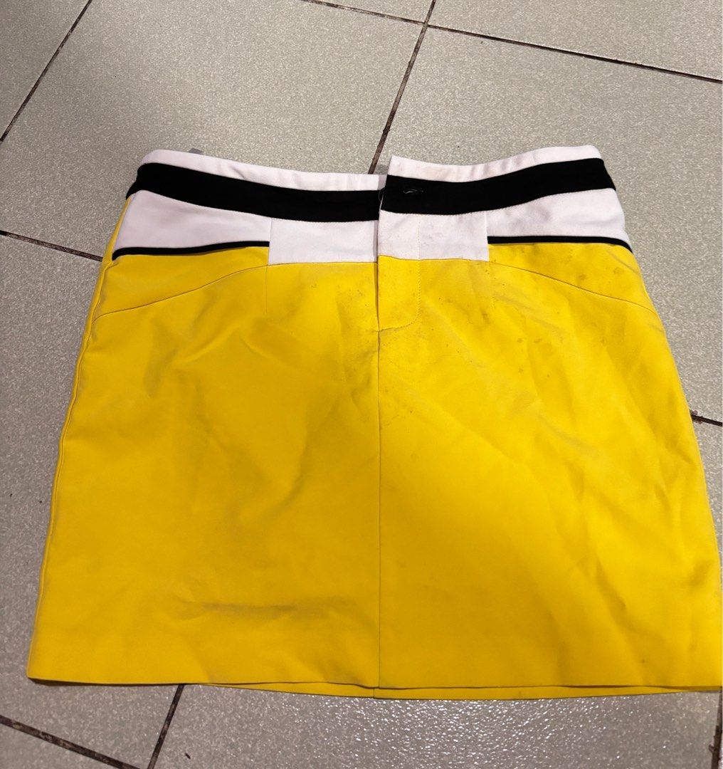 Yellow Mini Skirt with Color Block Detail (Category: Skirts) located in Taguig. Submitted by barbequeIU (Listing ID 1410411237, Image 2). Description: 25-26 - Vibrant yellow skirt - Unique color block waistband (white and black) - Classic A-line silhouette - Made of smooth, possibly woven fabric - Simple and clean design - Great for casual outfits.