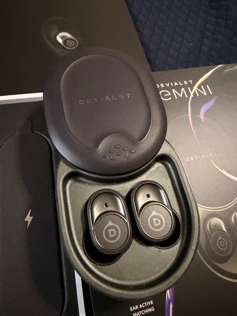 Devialet Gemini (Category: Earphones) located in Singapore. Submitted by twikz23 (Listing ID 1410607909, Image 6). Description: The Devialet Gemini 1 (or original Gemini) is a premium set of true wireless earbuds known for bringing Devialet’s acclaimed audio engineering into a portable format, featuring strong Active Noise Cancellation (ANC), Ear Active Matching (EAM) for personalized sound, IPX4 water resistance, aptX codec support, and a comfor