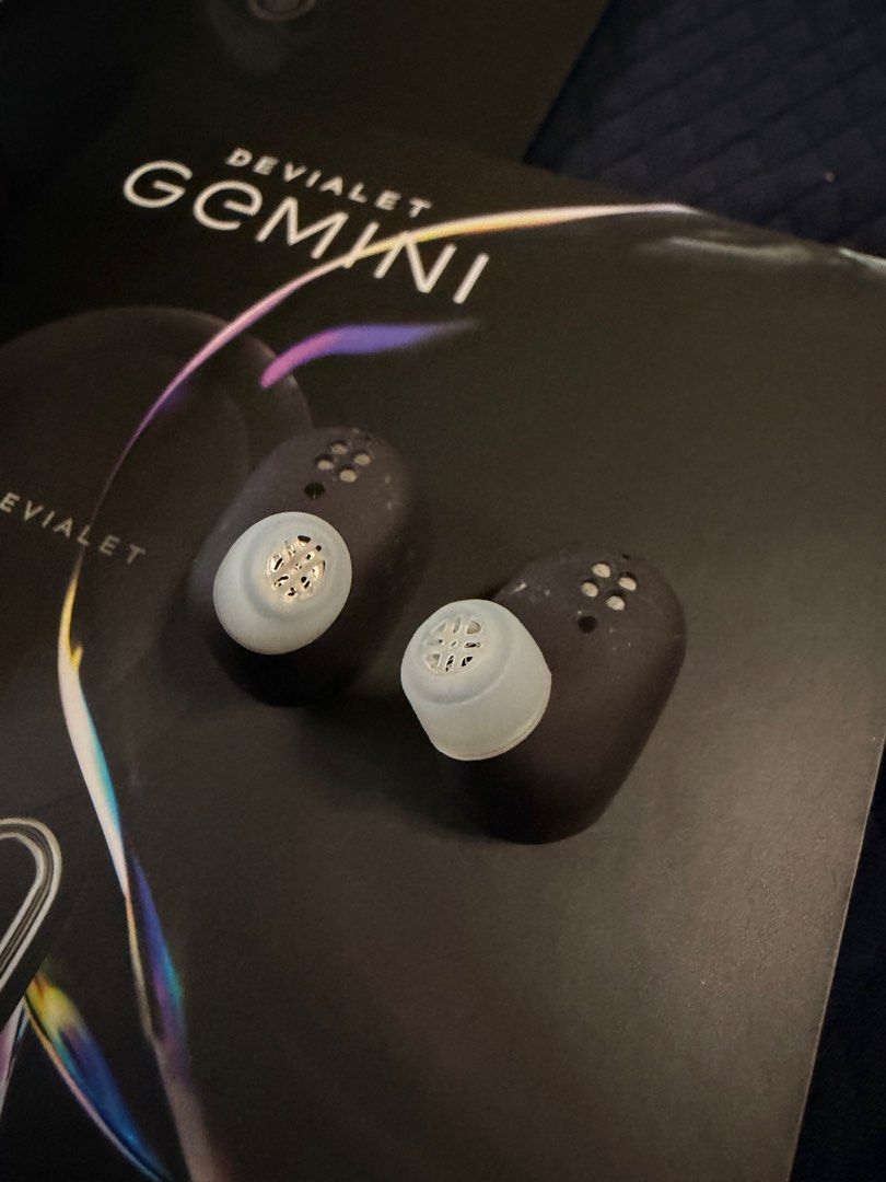 Devialet Gemini (Category: Earphones) located in Singapore. Submitted by twikz23 (Listing ID 1410607909, Image 8). Description: The Devialet Gemini 1 (or original Gemini) is a premium set of true wireless earbuds known for bringing Devialet’s acclaimed audio engineering into a portable format, featuring strong Active Noise Cancellation (ANC), Ear Active Matching (EAM) for personalized sound, IPX4 water resistance, aptX codec support, and a comfor