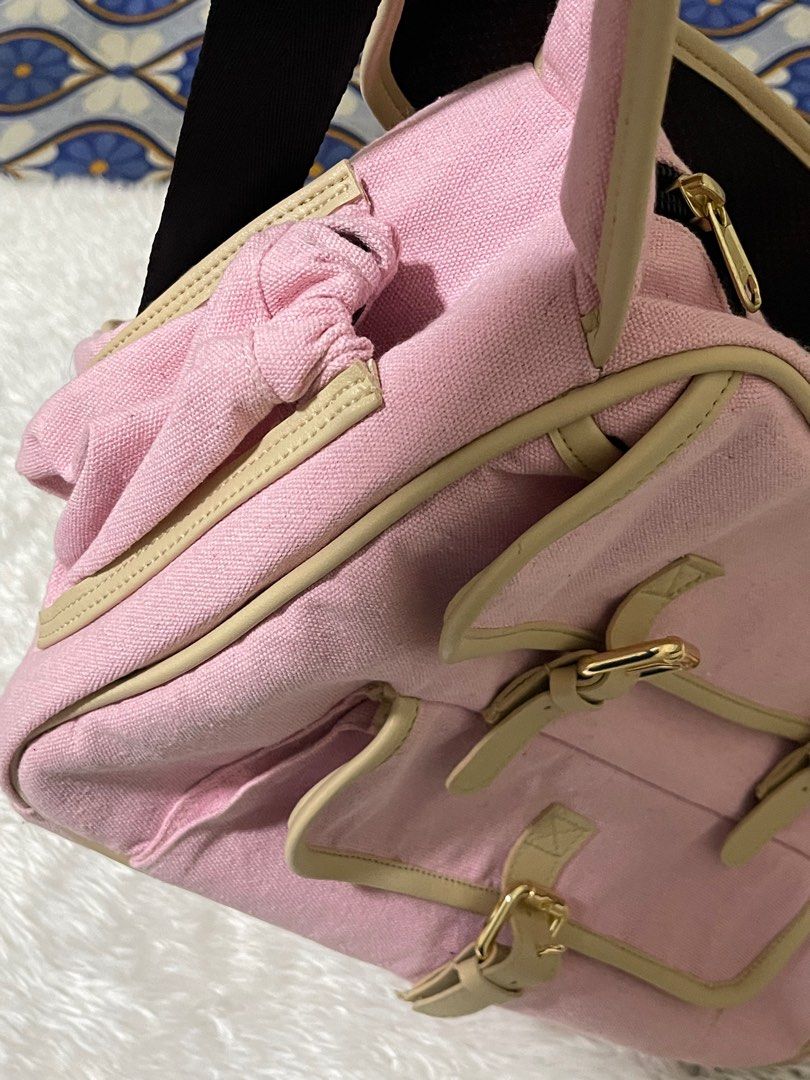 Dog bag/Dog carrier (Category: Homes & Other Pet Accessories) located in Manila. Submitted by loveditemsbyj (Listing ID 1410608832, Image 3). Description: - Pink shoulder bag - Beige accents - Gold-colored buckles - Long, adjustable strap with black mesh for comfort - Multiple compartments - Two front pockets - Zippered main compartment - Black interior lining.
