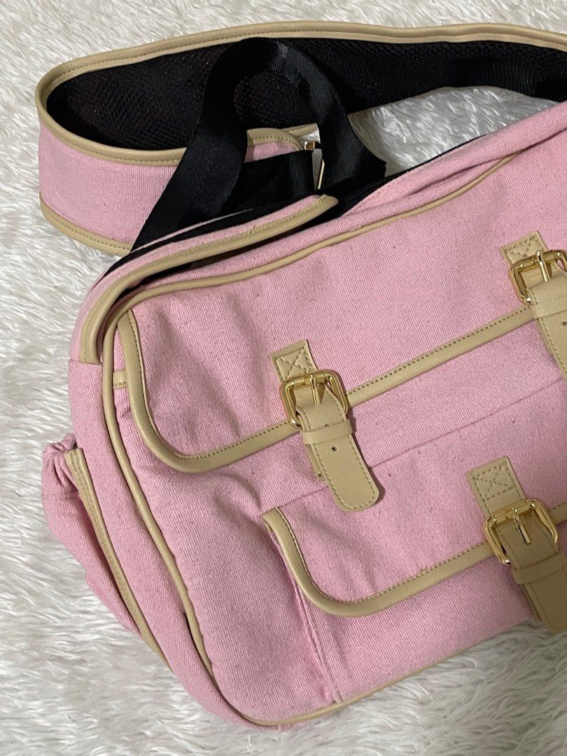 Dog bag/Dog carrier (Category: Homes & Other Pet Accessories) located in Manila. Submitted by loveditemsbyj (Listing ID 1410608832, Image 2). Description: - Pink shoulder bag - Beige accents - Gold-colored buckles - Long, adjustable strap with black mesh for comfort - Multiple compartments - Two front pockets - Zippered main compartment - Black interior lining.