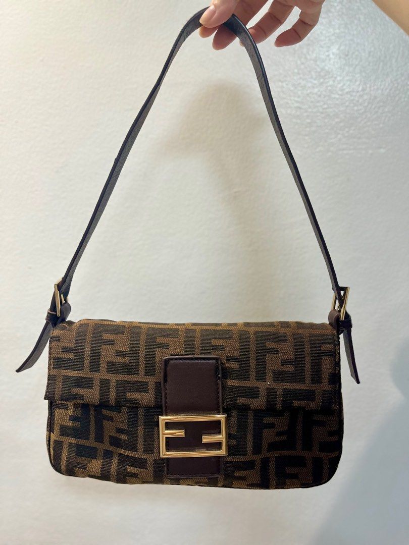 Fendi Zucca Baguette Bag (Category: Luxury Bags & Wallets) located in Manila. Submitted by seagypseaph (Listing ID 1410636898, Image 2). Description: 20% OFF! Happening from May 18-25! OG Price: Php6,200 Fendi vintage Zucca baguette bag Rank A-AB (lightly used with light visible marks) (not guaranteed auth) Condition: The overall bag looks like brand new but the strap has visible signs of use/peeling. Comes with a generic dustbag. You may opt to 