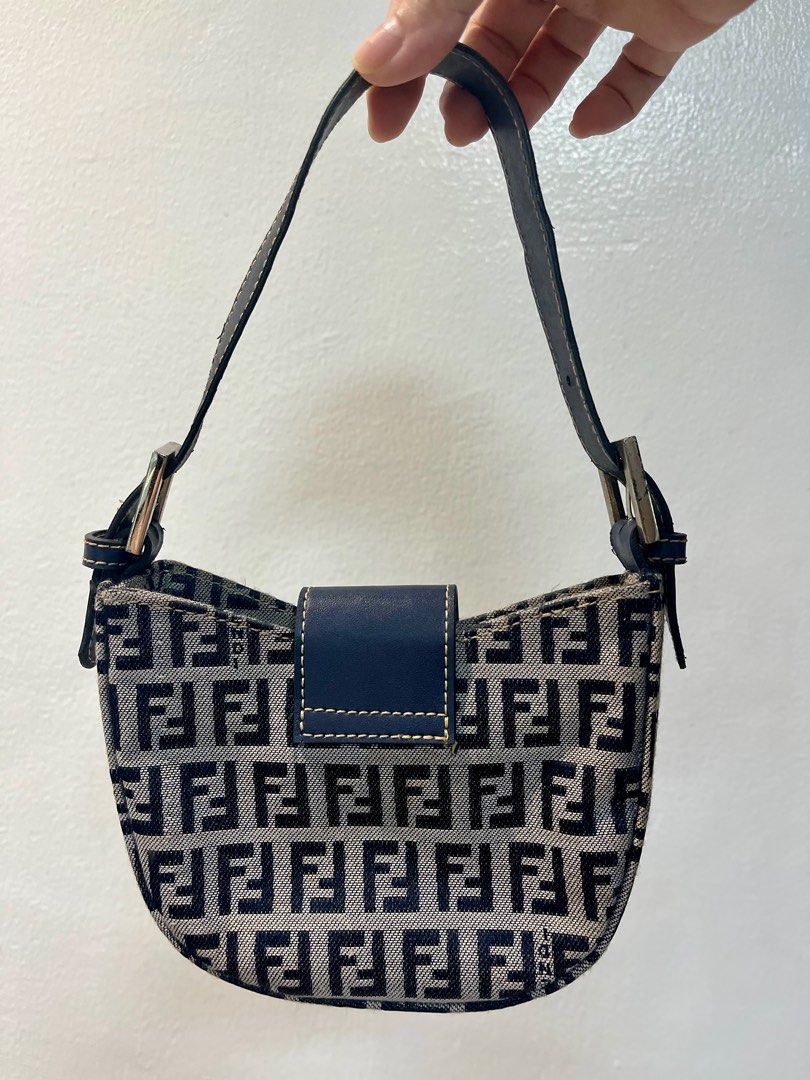 Fendi Zucca Mini FF Plaque (Croissant) Bag (Category: Luxury Bags & Wallets) located in Manila. Submitted by seagypseaph (Listing ID 1410633675, Image 2). Description: 20% OFF! Happening from May 18-25! OG Price: Php7,200 Fendi 1990-2000s Zucca Mini FF Plaque Vintage Bag - Iconic FF logo pattern - Navy blue leather strap - Silver-toned hardware - Crescent shape with rectangular base - Nano size Price negotiable. DM me! Rank: A-AB (Very good - to 