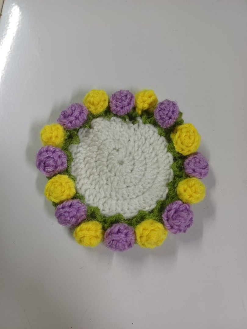 Flower Coaster (Category: Handmade Craft) located in Singapore. Submitted by maydoraemon (Listing ID 1410578564, Image 1). Description: Handmade Crochet Flower Coaster in sweet purple and yellow colors. Colors can be customized. Great as a gift..