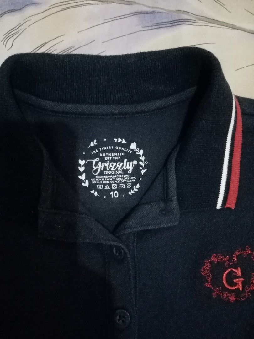 Grizzly Polo Shirt - Size 10 (Category: Babies & Kids Fashion) located in Antipolo. Submitted by cone0812 (Listing ID 1410554265, Image 3). Description: - Grizzly polo shirt - Color: Dark blue - Size: 10 Length - 19 inches Shoulder-12 inches Armpit to armpit - 13 inches.