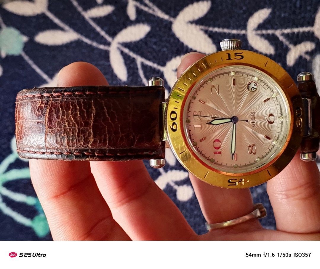 Guess Watch with Leather Strap (Category: Luxury Watches) located in Manila. Submitted by swiftfalcon-a2f0 (Listing ID 1410658783, Image 2). Description: - Gold-toned bezel - Silver dial - Brown leather strap - Date display at 3 o'clock - Water resistant to 100 meters - Japan movement.
