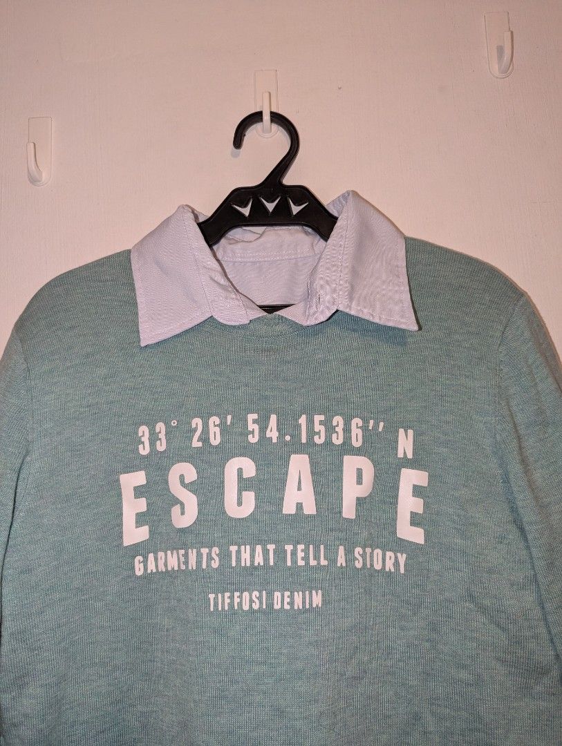 SOLID Escape Sweater Only (Category: Sets or Coordinates) located in Porac. Submitted by themightythrift (Listing ID 1410629844, Image 3). Description: - ISOLID Escape Sweater: Light blue with "ESCAPE" print, coordinates, and "GARMENTS THAT TELL A STORY TIFFOSI DENIM" text. - Features a light blue collar. - Includes a pair of beige trousers. - Comfortable and stylish outfit..