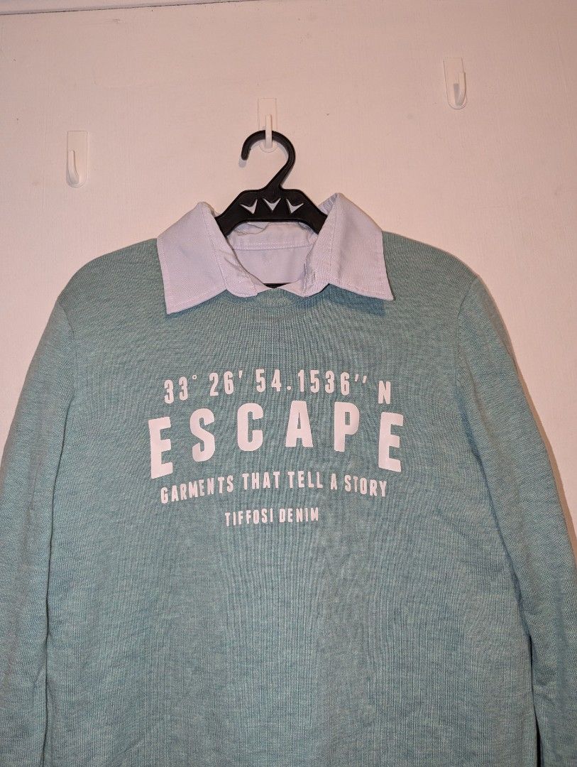 SOLID Escape Sweater Only (Category: Sets or Coordinates) located in Porac. Submitted by themightythrift (Listing ID 1410629844, Image 2). Description: - ISOLID Escape Sweater: Light blue with "ESCAPE" print, coordinates, and "GARMENTS THAT TELL A STORY TIFFOSI DENIM" text. - Features a light blue collar. - Includes a pair of beige trousers. - Comfortable and stylish outfit..