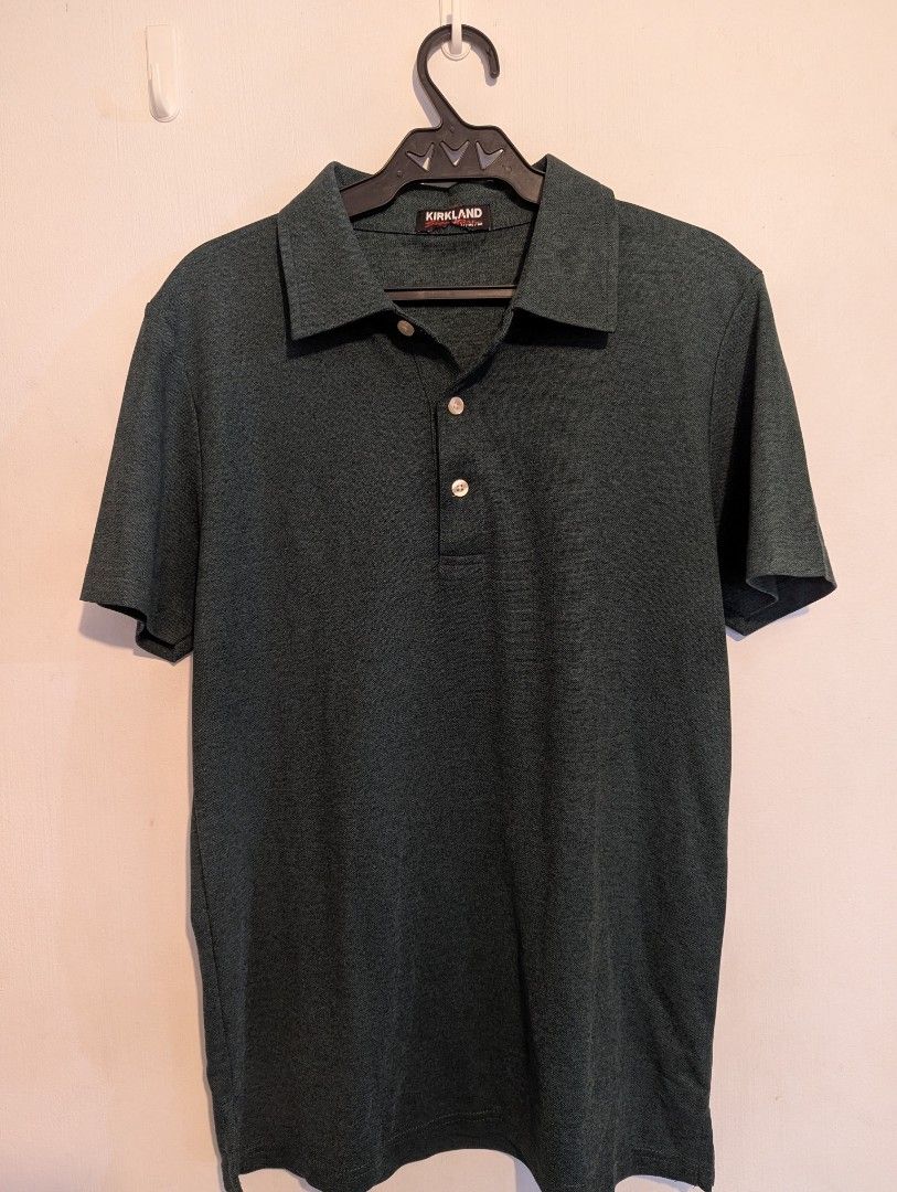 Kirkland Polo Shirt (Category: Tshirts & Polo Shirts ) located in Porac. Submitted by themightythrift (Listing ID 1410631044, Image 1). Description: - Dark green Kirkland polo shirt - Classic collar - Short sleeves - Three-button placket - Kirkland logo on collar - Breathable fabric.