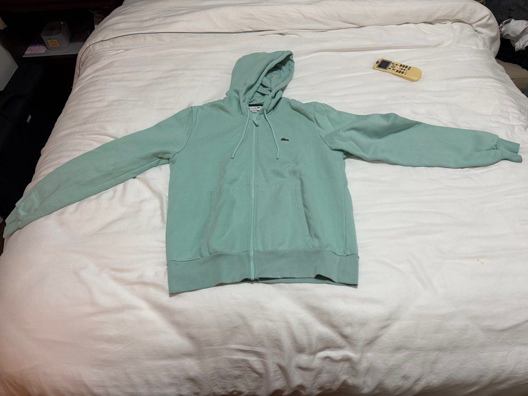 Lacoste Classic Fit Zip Hoodie (Category: Hoodies) located in Manila. Submitted by inob2024 (Listing ID 1410674846, Image 1). Description: - Lacoste zip-up hoodie - Light green color - Size: FR 4 / US M - Classic fit - Made in Turkiye - Features a hood and front pocket - Lacoste logo on chest.