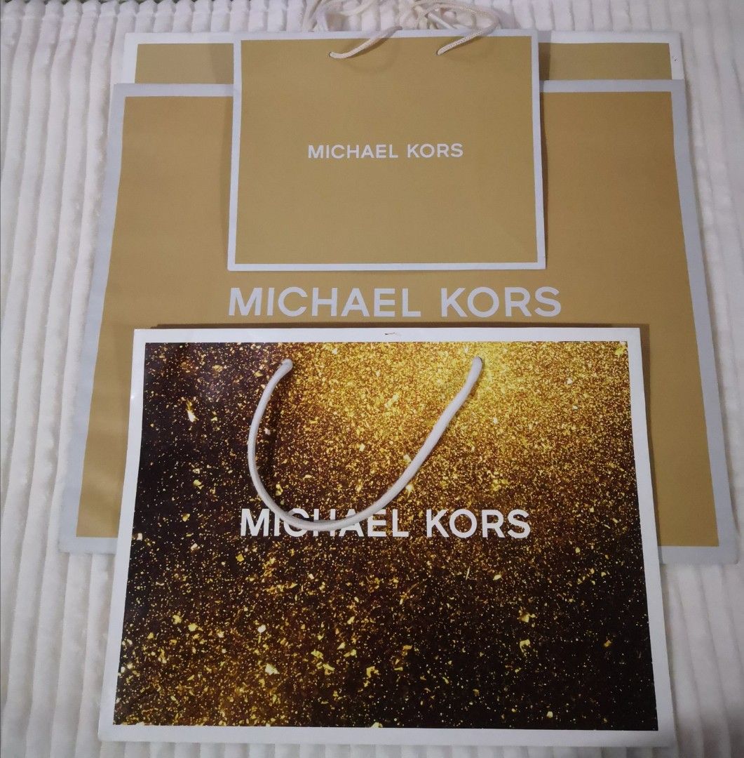 Michael Kors Original Paper Bags (Category: Luxury Bags & Wallets) located in Mandaluyong City. Submitted by ilovemyshop (Listing ID 1410611644, Image 2). Description: - Set of Michael Kors shopping bags - Includes various sizes - Features gold and brown designs - Michael Kors logo prominently displayed - Perfect for gifting - Ideal for collectors Price and sizes as follows: Large 400 each - 19 x 15 x 7 inches Medium 300 - SOLD Small 200 - 10 x 8