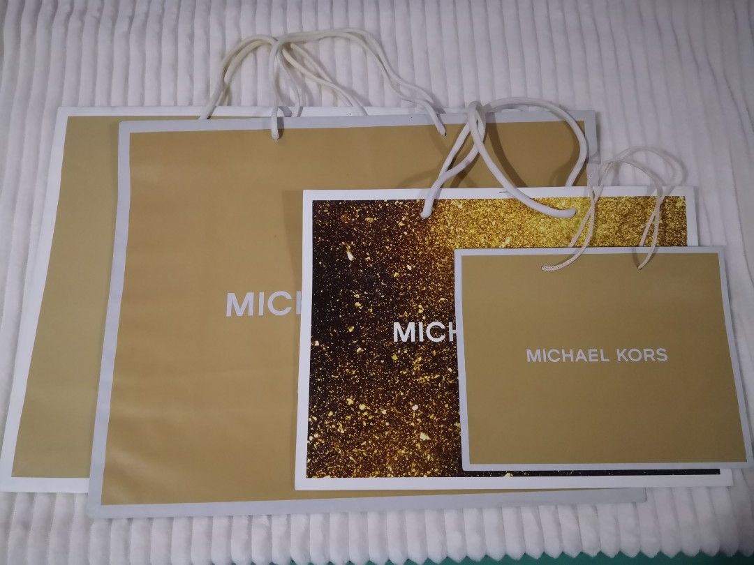 Michael Kors Original Paper Bags (Category: Luxury Bags & Wallets) located in Mandaluyong City. Submitted by ilovemyshop (Listing ID 1410611644, Image 1). Description: - Set of Michael Kors shopping bags - Includes various sizes - Features gold and brown designs - Michael Kors logo prominently displayed - Perfect for gifting - Ideal for collectors Price and sizes as follows: Large 400 each - 19 x 15 x 7 inches Medium 300 - SOLD Small 200 - 10 x 8