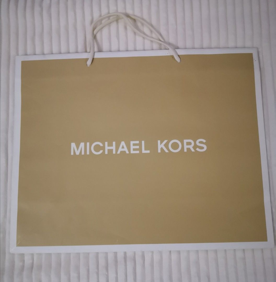 Michael Kors Original Paper Bags (Category: Luxury Bags & Wallets) located in Mandaluyong City. Submitted by ilovemyshop (Listing ID 1410611644, Image 3). Description: - Set of Michael Kors shopping bags - Includes various sizes - Features gold and brown designs - Michael Kors logo prominently displayed - Perfect for gifting - Ideal for collectors Price and sizes as follows: Large 400 each - 19 x 15 x 7 inches Medium 300 - SOLD Small 200 - 10 x 8