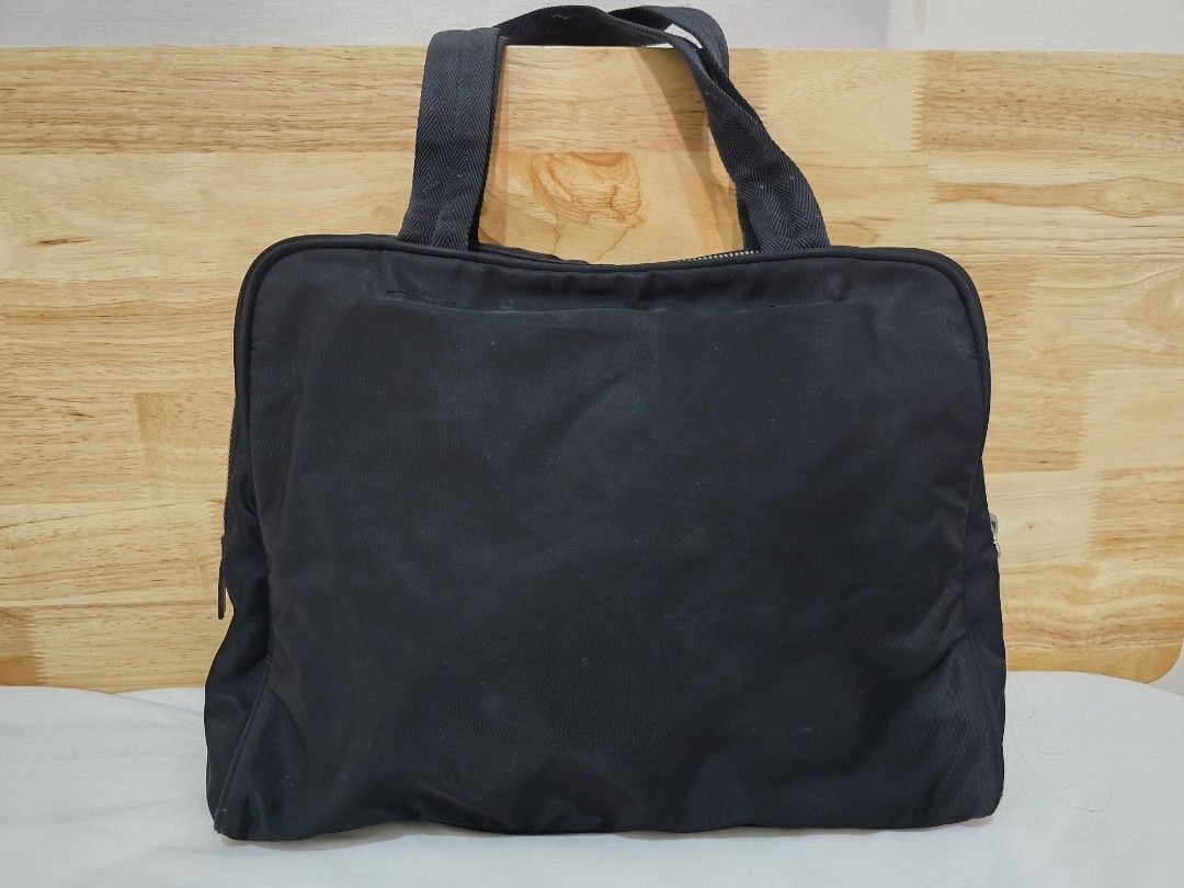 Original Prada Tessuto Nylon Tote Bag (Category: Luxury Bags & Wallets) located in Cavite. Submitted by everythingjapan (Listing ID 1410662815, Image 2). Description: Original Prada Tessuto Nylon Vintage Tote very functional zipped interior pocket zipped enclosure flaws: no puller rip in interior edge (can easily have it stitched in any bag repair shop or can still use as is if not finicky) can provide certificate of authenticity dimensions: 12 x