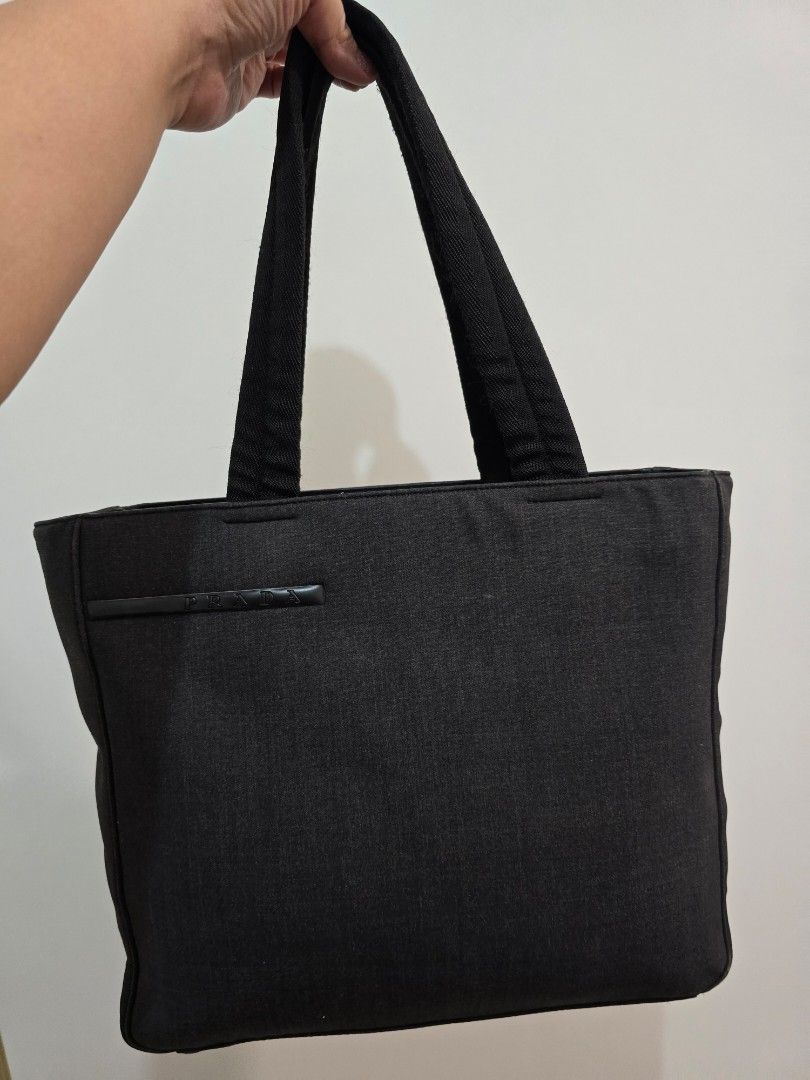Original Prada Tessuto Tote Bag (Category: Luxury Bags & Wallets) located in Cavite. Submitted by everythingjapan (Listing ID 1410651567, Image 3). Description: Original Prada Tessuto Canvas Tote beautiful condition super functional clean inside and out with original prada authenticity card drop down handle length: 8 inches dimensions: 14 x 10 x 4 inches.