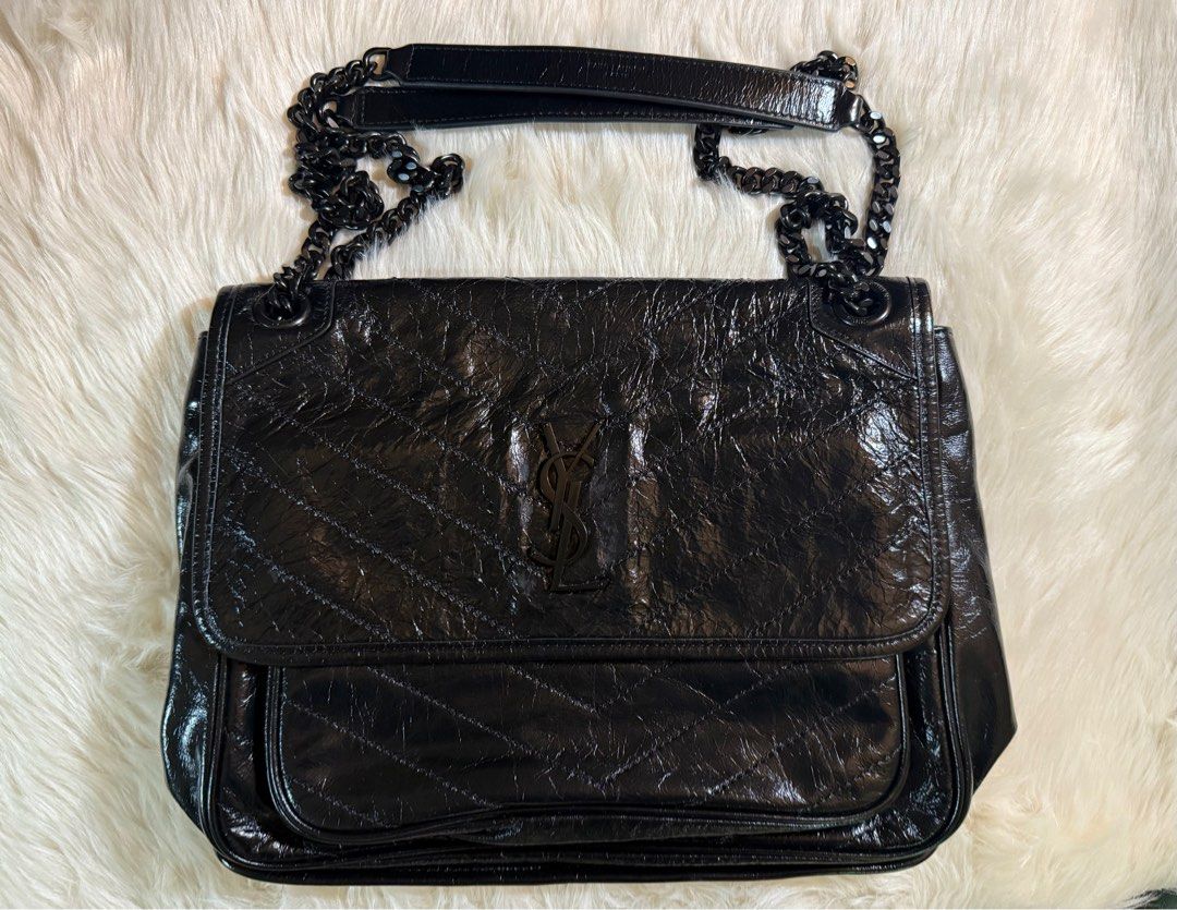 Saint Laurent Niki Bag (Category: Luxury Bags & Wallets) located in Iloilo. Submitted by amc517 (Listing ID 1410702253, Image 1). Description: - Authentic Saint Laurent Niki bag - Black color - Chain strap - Quilted design - Glossy finish - Includes dust bag and cards - peeling near ysl logo - Made in Italy (leather tag inside) - Saint Laurent logo visible.
