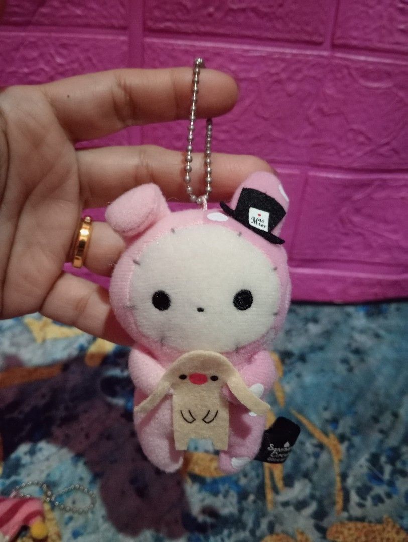 Sentimental Circus Plush Keychains set (Category: Plushies & Soft Toys) located in Bulacan. Submitted by renasophiatoystore2020 (Listing ID 1410656039, Image 3). Description: - Sentimental Circus plush keychains - Features Shappo and a pink bunny character - Pink bunny wearing a top hat - Includes metal chain for easy attachment - Official tags: "Sentimental Circus ©2012 San-X".