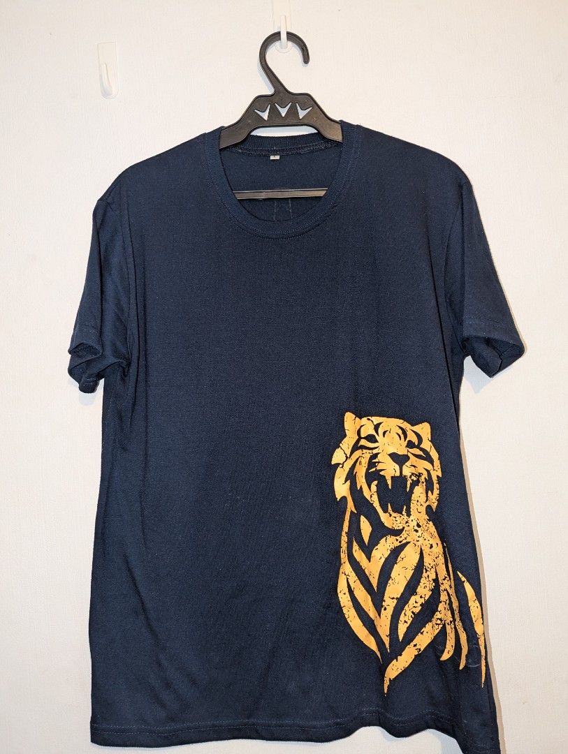 Tiger Beer Graphic T-Shirt (only) (Category: Tshirts & Polo Shirts ) located in Porac. Submitted by themightythrift (Listing ID 1410630102, Image 2). Description: - Navy blue Tiger Beer t-shirt: - Features a tiger graphic on the front. - Includes a beer bottle graphic with the Tiger Beer logo on the back. - Crew neck style. .