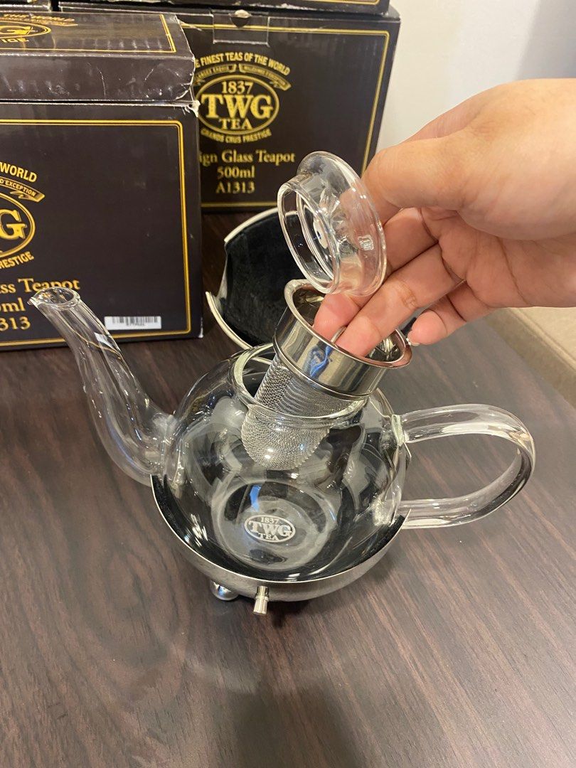TWG Design Glass Teapot 500ml (Category: Coffee & Tea Tableware) located in Pateros City. Submitted by dendenden15 (Listing ID 1410630902, Image 3). Description: Original Price 16,500 Selling for 50% Lesser and still negotiable - Elegant TWG design glass teapot - 500ml capacity - Stainless steel base - Clear glass body - Removable infuser for loose leaf tea - Unique spherical shape - Glass spout and handle - Comes with original box .