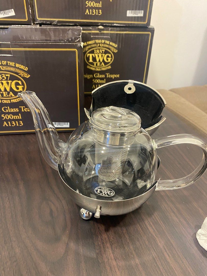 TWG Design Glass Teapot 500ml (Category: Coffee & Tea Tableware) located in Pateros City. Submitted by dendenden15 (Listing ID 1410630902, Image 2). Description: Original Price 16,500 Selling for 50% Lesser and still negotiable - Elegant TWG design glass teapot - 500ml capacity - Stainless steel base - Clear glass body - Removable infuser for loose leaf tea - Unique spherical shape - Glass spout and handle - Comes with original box .