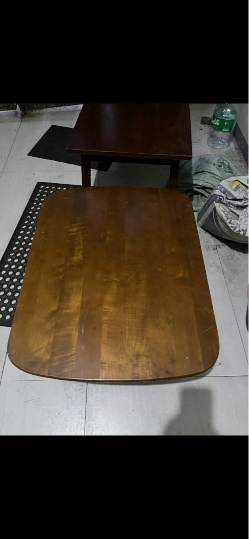 Wooden Coffee Table (Category: Tables & Sets) located in Pasay City. Submitted by beye01 (Listing ID 1410698480, Image 1). Description: - Rectangular wooden coffee table with rounded corners. - Warm brown finish. - Dimensions: 750mm wide x 600mm deep x 300mm high. - Made of natural wood with urethane resin coating. - Avoid direct sunlight and heat. - Do not place heated pots or use strong detergents. Lamp sold separately. Table legs can be folded