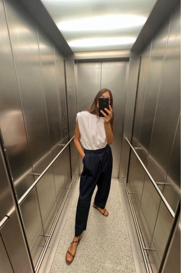 Zara Jumpsuit with Contrast Poplin (Category: Jumpsuits) located in Manila. Submitted by belletsy (Listing ID 1410657728, Image 2). Description: - Zara jumpsuit - White poplin top with round neckline and shoulder details - Dark navy pleated wide-leg bottom - Chic and modern style.