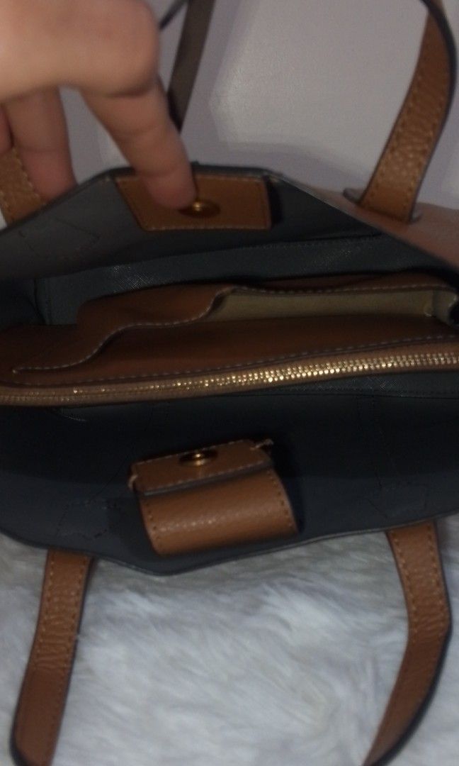 Brown Leather Handbag (Category: Luxury Bags & Wallets) located in Bacolor. Submitted by pinktintmine (Listing ID 1407438127, Image 3). Description: - Brown leather exterior - Structured design - Top handle - Magnetic closure - Interior zippered compartment - Additional pockets - Contrasting interior color - Visible stitching on handles.
