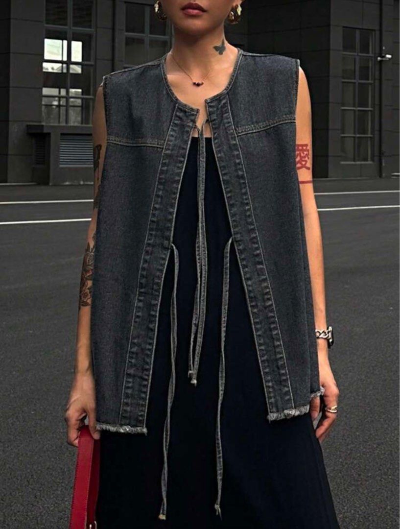 Denim Vest with Tie Detail (Category: Sleeveless) located in Quezon City. Submitted by monisea (Listing ID 1407444377, Image 2). Description: - Dark wash denim vest - Sleeveless design - Features a unique tie detail - Raw hem finish - Versatile for various outfits - Perfect for layering.