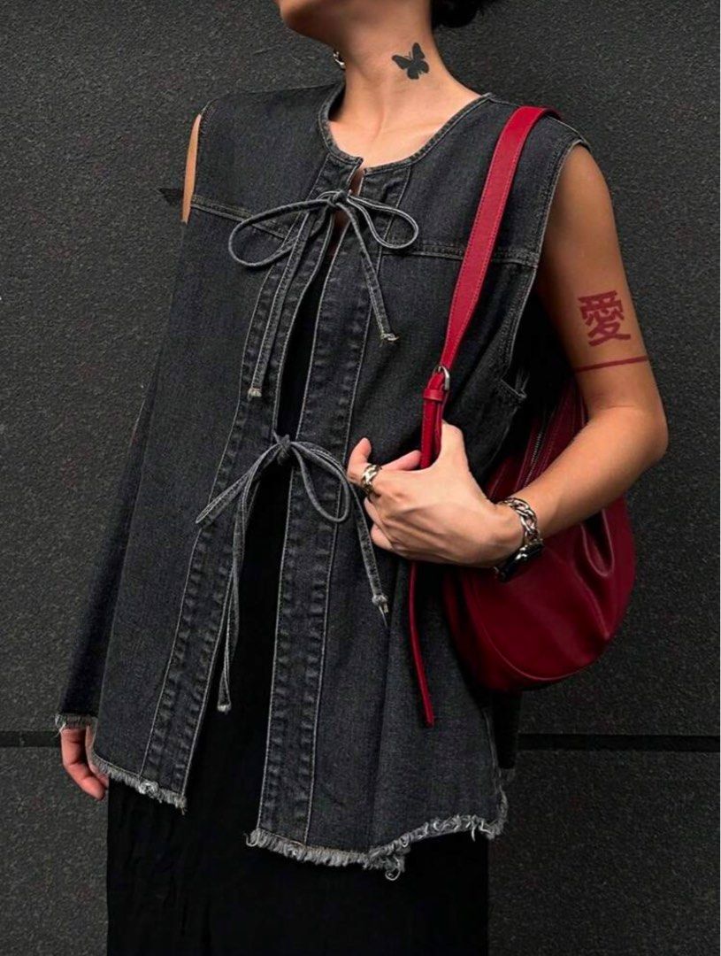 Denim Vest with Tie Detail (Category: Sleeveless) located in Quezon City. Submitted by monisea (Listing ID 1407444377, Image 1). Description: - Dark wash denim vest - Sleeveless design - Features a unique tie detail - Raw hem finish - Versatile for various outfits - Perfect for layering.