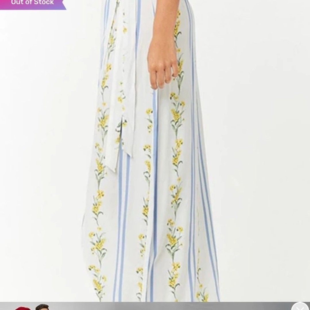 Floral Striped Maxi Dress (Category: Dresses) located in Taguig. Submitted by schnitka (Listing ID 1407481719, Image 2). Description: - White maxi dress with blue vertical stripes and floral accents. - Wrap-style design. - Features a high slit. - Lightweight fabric, ideal for warm weather. - Tie closure at the waist. - Ankle-length..