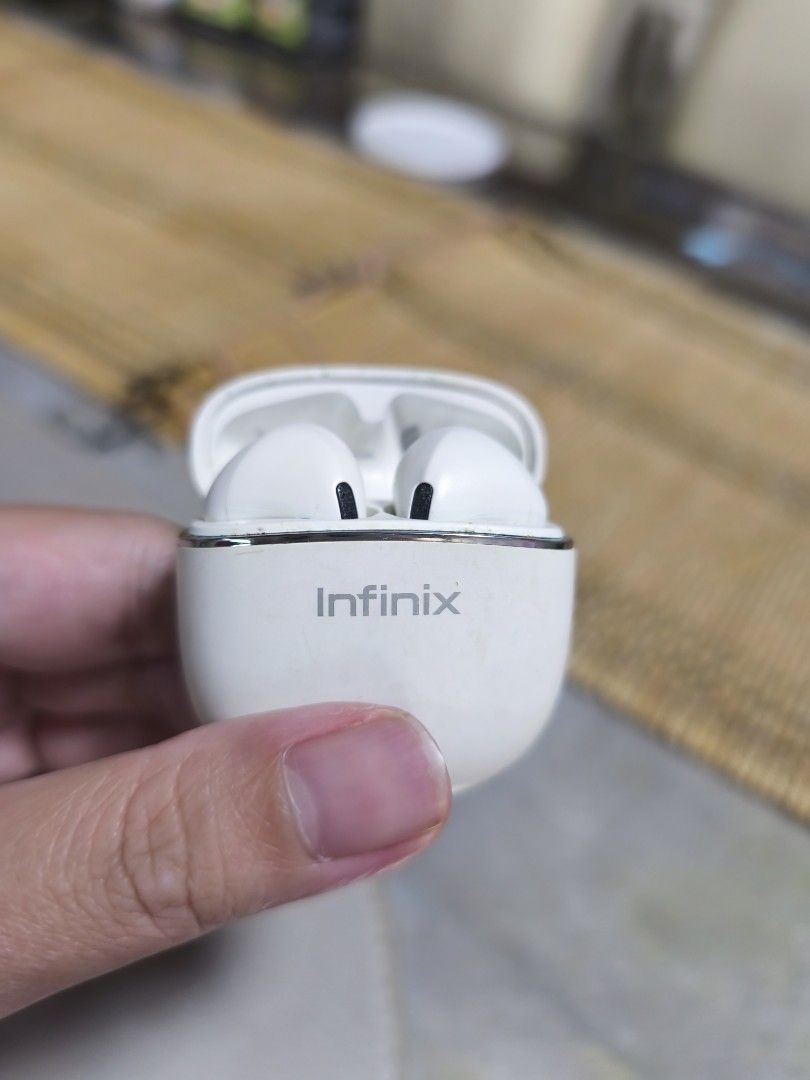 Infinix Wireless Earbuds (Category: Earphones) located in Manila. Submitted by decutteringbyjel (Listing ID 1407414612, Image 1). Description: - White Infinix wireless earbuds - Includes charging case with Infinix logo - Sleek case design - Charging indicator on case.