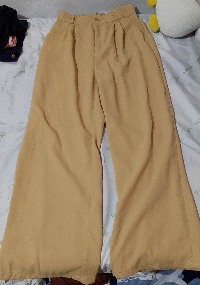 Khaki Wide Leg Trouser Pants - 30 (Category: Other Bottoms) located in Pasig City. Submitted by lizasxnw (Listing ID 1407432772, Image 2). Description: - Khaki wide-leg pants - Button closure - Front pleats - Relaxed fit - Lightweight fabric - Versatile style.