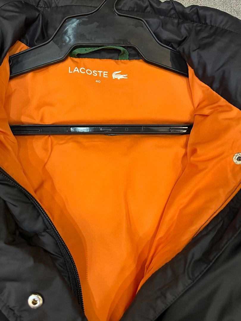 Lacoste Puffer Jacket (Category: Coats, Jackets and Outerwear) located in Manila. Submitted by mdeclutterrr (Listing ID 1407486193, Image 3). Description: Lacoste puffer jacket Cropped fit Black exterior - orange interior Not reversible Used 3x for winter trip Bought in Japan.
