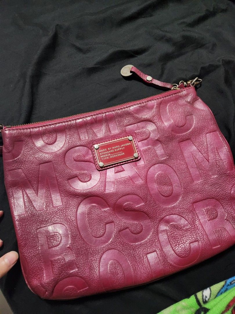 Marc by Marc Jacobs sling bag (Category: Luxury Bags & Wallets) located in Pasig City. Submitted by hexadx (Listing ID 1407444131, Image 2). Description: - Marc by Marc Jacobs clutch - Vibrant pink color - Embossed brand lettering - Zipper closure - Small wrist strap - Rectangular shape - Small metal brand tag - Perfect for essentials authentic still good need lang ng deep cleaning o laba nung loob can do lalamove/pick up pasig city sf shouldered