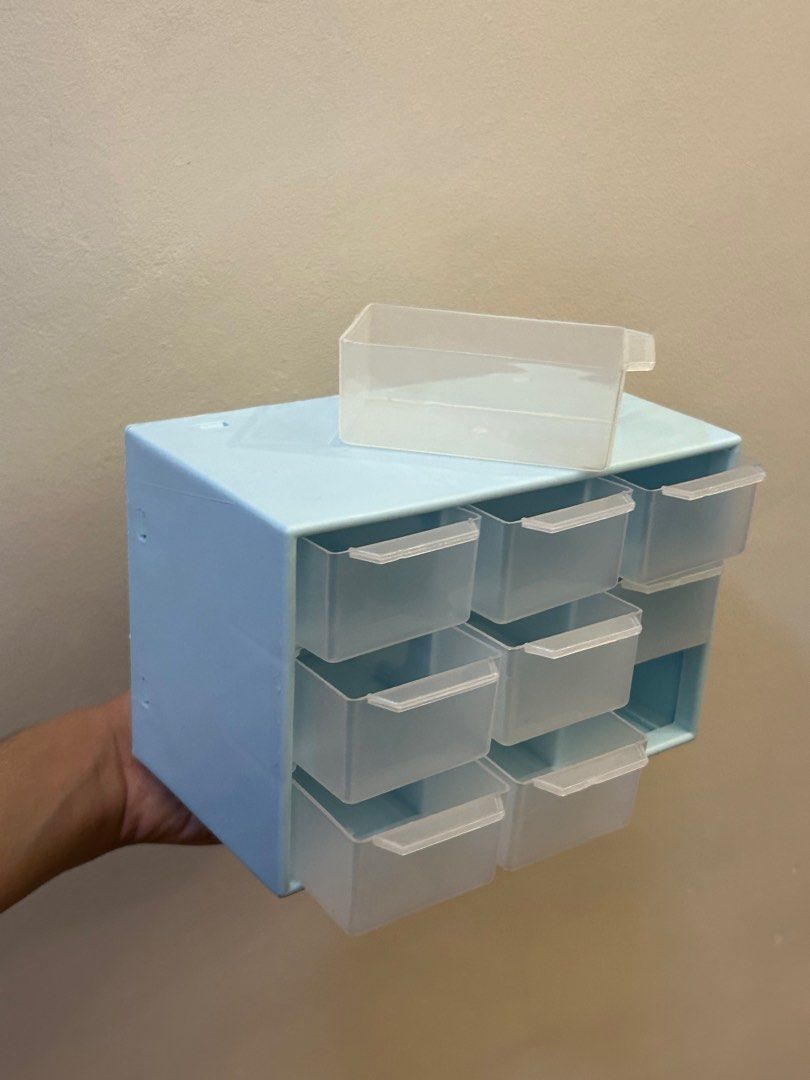 Mini Drawer Storage Organizer (Category: Storage Boxes & Baskets) located in Taguig. Submitted by lyeche3 (Listing ID 1407555999, Image 3). Description: Blue in color. Small organizer with 9 drawers. Good for jewelry, trinkets, accessories etc. I have 2 of these Size: • Width: 10cm • Length: 18cm • Height: 12cm.