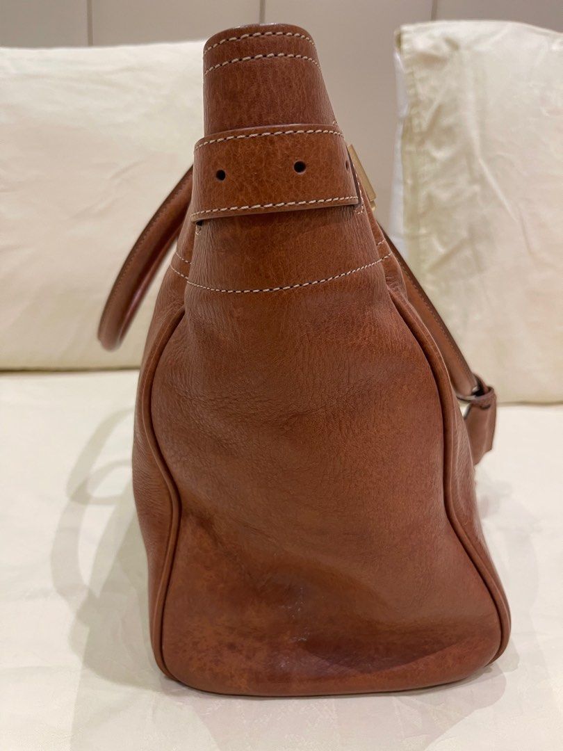 Mulberry Oak Brass Tote Bag (Category: Luxury Bags & Wallets) located in Calamba. Submitted by lorlina (Listing ID 1407427300, Image 2). Description: - Authentic Mulberry handbag - Beautiful brown color - Top handle design with buckle details - Secure lock closure - Interior zipped pocket - Mulberry branded tag - Spacious interior - Made of high-quality leather - Includes original receipt - With dustbag & box Just needs cleaning and conditioning 
