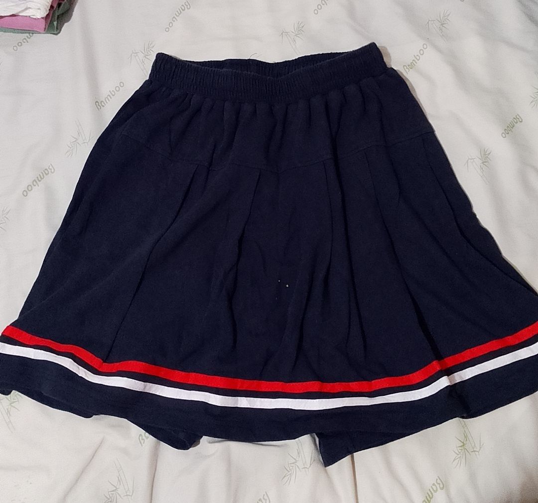 Navy Blue Skirt with Shorts (Category: Skirts) located in Pasig City. Submitted by lizasxnw (Listing ID 1407453116, Image 1). Description: - Navy blue skirt - Red and white striped hem - Elastic waistband - Includes navy blue shorts underneath - Made of soft fabric.