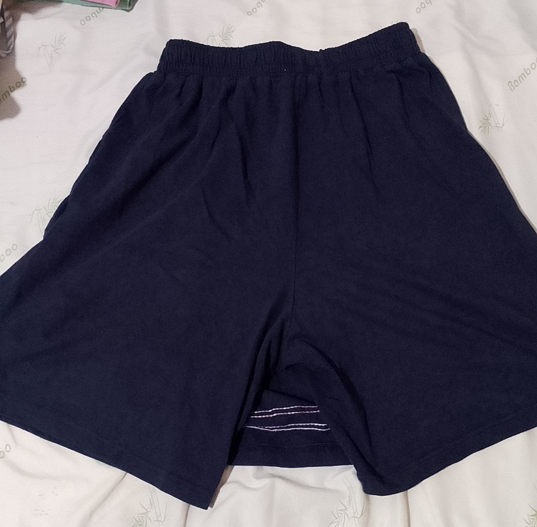 Navy Blue Skirt with Shorts (Category: Skirts) located in Pasig City. Submitted by lizasxnw (Listing ID 1407453116, Image 3). Description: - Navy blue skirt - Red and white striped hem - Elastic waistband - Includes navy blue shorts underneath - Made of soft fabric.