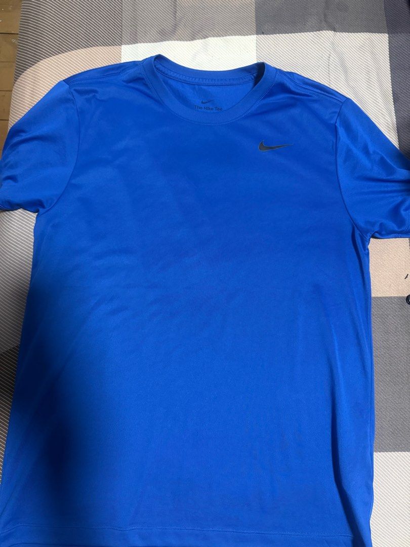 Nike drifit T-shirt (Category: Tshirts & Polo Shirts ) located in Quezon City. Submitted by jaypee0 (Listing ID 1407448191, Image 1). Description: - Blue Nike T-shirt - Features the iconic Nike logo on the chest - Made from a smooth, athletic material - Classic crew neck design - Short sleeves for comfort - Branded with "The Nike Tee" tag Used trice.