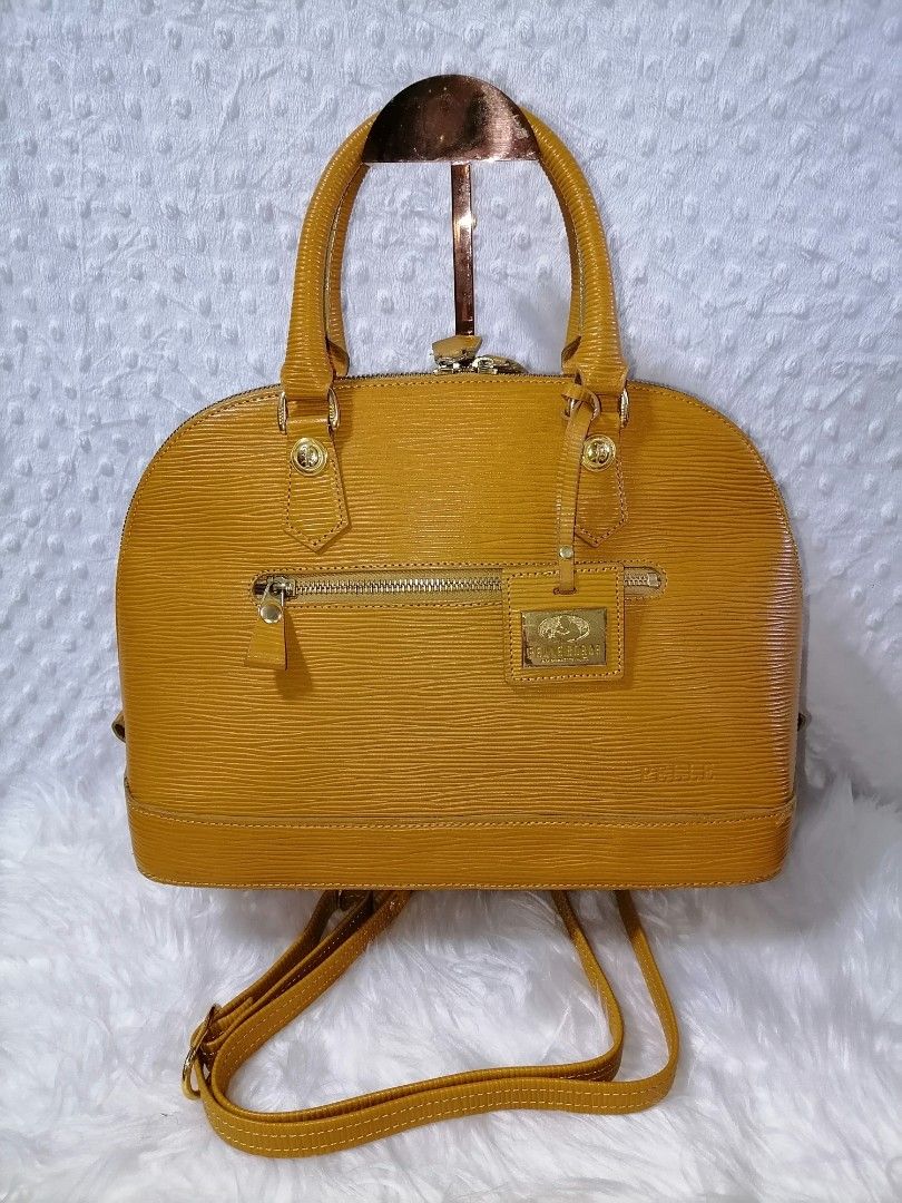 Pelle Borsa Mustard Yellow Handbag (Category: Luxury Bags & Wallets) located in Butuan. Submitted by az-branded.items (Listing ID 1407433236, Image 1). Description: Mustard yellow Pelle Borsa handbag with top handles and a detachable shoulder strap. Features a zip closure, an exterior zip pocket, and a gold-tone metal logo tag. The interior has a brown lining with multiple compartments. Includes a small tag with the code A05107 YE. The bag has a 